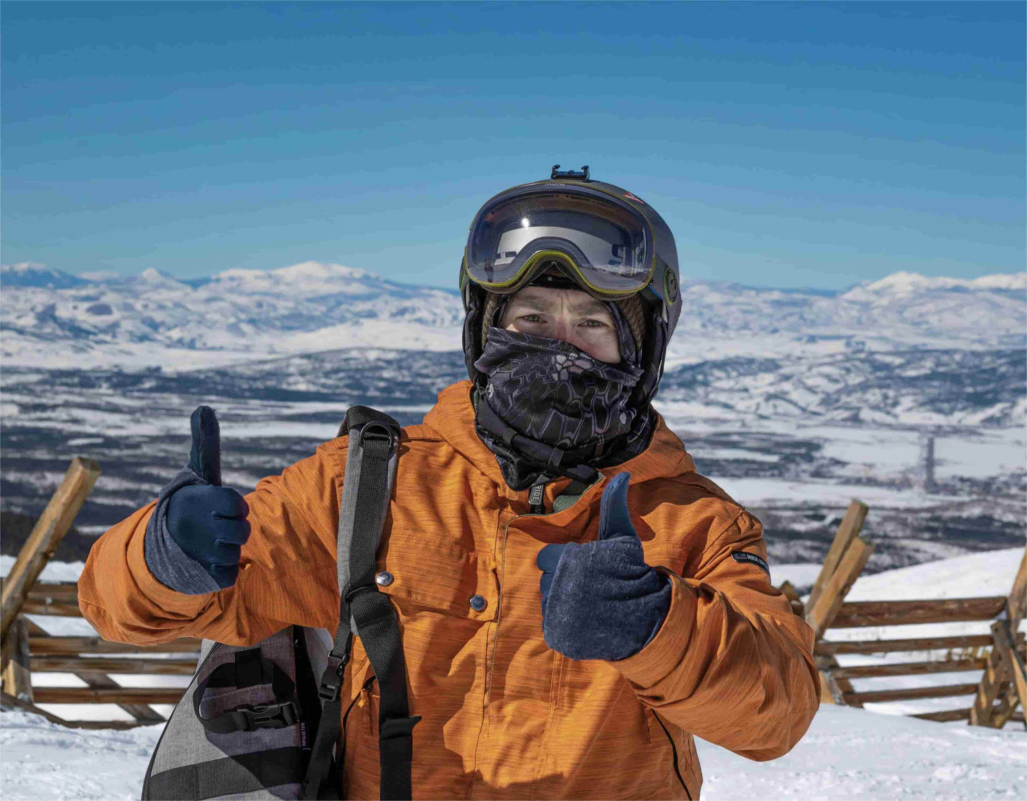 Person wearing Arcfomor heated gloves in snowy mountain conditions